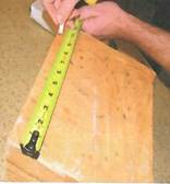 A person measuring a piece of wood
AI-generated content may be incorrect.